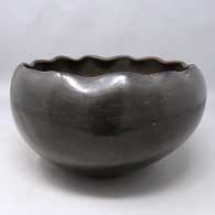 Black bowl with a pie crust rim
 by Unknown of Ohkay Owingeh