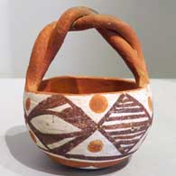 Polychrome friendship basket with twisted handle and geometric design 
 by Unknown of Isleta