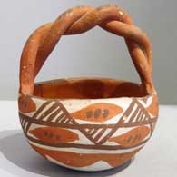 Polychrome friendship basket with twisted handle and geometric design 
 by Unknown of Isleta