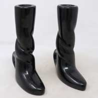 Pair of black candlestick holders in shape of boots carved with twisted stems
 by Unknown of Santa Clara