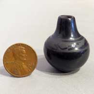 Miniature black-on-black jar with an avanyu and geometric designF17
 by Dolores Curran of Santa Clara