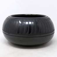 Black on black jar with a band of feathers design
 by Blue Corn of San Ildefonso
