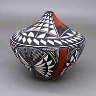 Polychrome jar with a painted red opening, and a black and white checkerboard, fine line, and geometric design
 by Sandra Victorino of Acoma