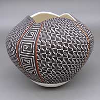 Polychrome jar with a square geometric cut opening and a geometric design based on a checkerboard background
 by Frederica Antonio of Acoma