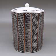 Polychrome lidded cylinder with a geometric design based around a checkerboard background and a matching lid
 by Frederica Antonio of Acoma