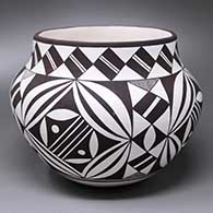 A black-on-white jar decorated with a four-panel geometric design around the shoulder and body and with a band of geometric design around the neck
 by Rebecca Lucario of Acoma
