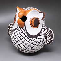 A classic polychrome Acoma owl figure decorated with feathers, wings, tail and a hooked beak
 by Hilda Antonio of Acoma