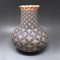 A tall polychrome jar with a pie crust rim and a pumpkin seed snowflake, fine line and geometric design
 by Unknown of Acoma