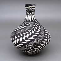 Black-on-white jar with an organic opening and a fine line, kiva step, feather ring, and geometric design
 by Sandra Victorino of Acoma