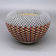 Polychrome jar with a concave opening and a geometric design based on a checkerboard background
 by Frederica Antonio of Acoma