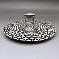 Black-on-white flat jar with a spiral mesa geometric design
 by Paula Estevan of Acoma