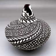 A black-on-white jar with a kiva-step cut opening and a spiraling geometric design around the body
 by Sandra Victorino of Acoma