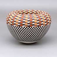 A polychrome Infinity jar with a checkerboard and geometric design around the body
 by Frederica Antonio of Acoma