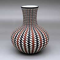 A tall-neck polychrome vase with a spiral checkerboard geometric design
 by Paula Estevan of Acoma