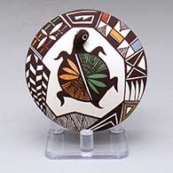 A polychrome seed pot decorated with a turtle, fine line and geometric design
 by Carolyn Concho of Acoma