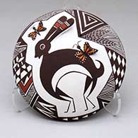 A polychrome seed pot decorated with appliques and a Mimbres rabbit, butterflies and geometric design
 by Carolyn Concho of Acoma
