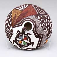 A small polychrome jar with a turtle head and lady bug applique and a fine line and geometric design above the shoulder
 by Carolyn Concho of Acoma