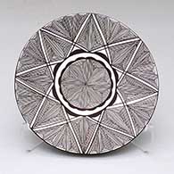 A black-on-white plate decorated with a fine line and geometric design
 by Alisha Sanchez of Acoma