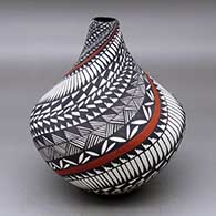 Click for a larger view A polychrome tear drop jar decorated with a spiral feather, fineline, kiva step and geometric design
by Sandra Victorino of Acoma