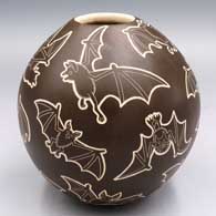 Brown-on-white jar with a sgraffito flying bat design
 by Adrian Corona of Mata Ortiz and Casas Grandes