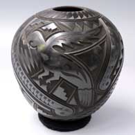 Black-on-black jar with a carved parrot, quail, serpent, lizard and geometric design
 by Martin Olivas of Mata Ortiz and Casas Grandes