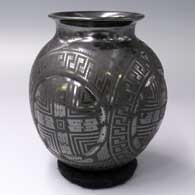 Black-on-black jar with a rolled lip, bulbous sides and a geometric and quadrillos design
 by Eligio Ortiz of Mata Ortiz and Casas Grandes