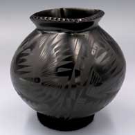 Black-on-black jar with a square, notched rolled lip and a 4-panel bird element and geometric design
 by Oscar Quezada of Mata Ortiz and Casas Grandes