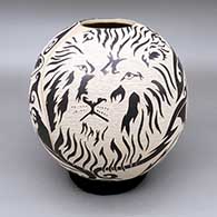Black-on-white jar with a graphic-style sgraffito leopard, rhino, zebra, lion, African buffalo, and geometric design
 by Abraham Rodriguez of Mata Ortiz and Casas Grandes