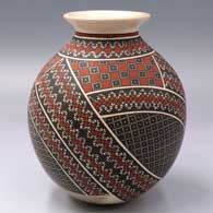 Polychrome jar with a rolled lip and 23-panel geometric design
 by Tati Ortiz of Mata Ortiz and Casas Grandes