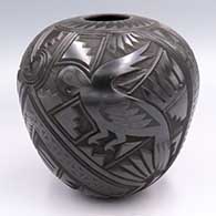 Black jar carved with a rabbit, roadrunner, parrot, serpent and geometric design
 by Martin Olivas of Mata Ortiz and Casas Grandes