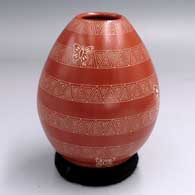 Red-and-white jar with a sgraffito butterfly and geometric design
 by Mariela Tena of Mata Ortiz and Casas Grandes