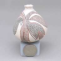 Miniature polychrome jar with an organic opening and a fine line and geometric design
 by Carla Martinez of Mata Ortiz and Casas Grandes