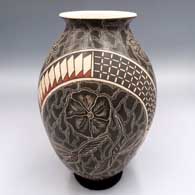 Polychrome jar with a flared lip and a sgraffito and painted flower, branch, mesh and geometric design
 by Julio Mora of Mata Ortiz and Casas Grandes