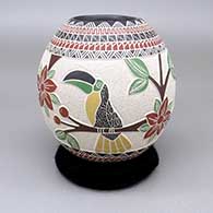 Polychrome jar with a sgraffito, lightly carved, and painted toucan, flower, berry, branch, and geometric design
 by Melissa Tena of Mata Ortiz and Casas Grandes
