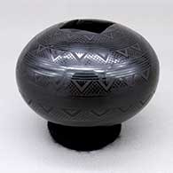 Small black-on-black jar with a square cut opening and a geometric design
 by Ruben Rodriguez of Mata Ortiz and Casas Grandes