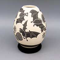 Black and white jar with sgraffito bat and flower design
 by Adrian Corona of Mata Ortiz and Casas Grandes