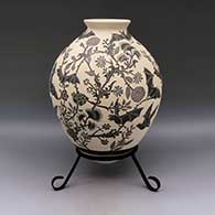 Large black and white jar with flared rim and sgraffito bat and flower design, click or tap to see a larger version
