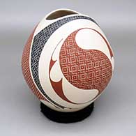 Polychrome jar with an oval organic cut opening and a painted geometric design
 by Elias Pena of Mata Ortiz and Casas Grandes