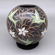 Polychrome jar with a sgraffito and painted hummingbird, flower, and geometric design
 by Elicena Cota of Mata Ortiz and Casas Grandes