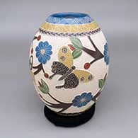 Polychrome jar with a lightly carved, sgraffito, and painted butterfly, branch, berry, flower, and geometric design
 by Melissa Tena of Mata Ortiz and Casas Grandes