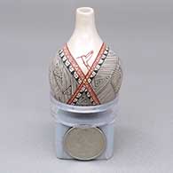 Miniature polychrome jar with an organic opening and a hummingbird and geometric design
 by Carla Martinez of Mata Ortiz and Casas Grandes