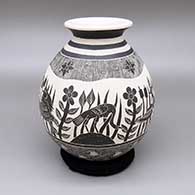Black and white jar with a flared opening and a sgraffito heron, fish, flower, cattail, and geometric design
 by Hilario Quezada Jr of Mata Ortiz and Casas Grandes