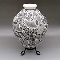 Large black and white jar with a flared opening and a sgraffito hummingbird, flower, and leaf design
 by Arturo Quezada of Mata Ortiz and Casas Grandes