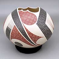 Polychrome jar with an organic cut opening and a painted geometric design
 by Elias Pena of Mata Ortiz and Casas Grandes