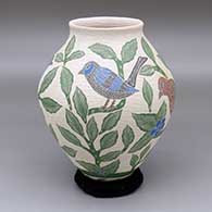 A polychrome jar with a raised lip and a sgraffito-and-painted bird, branch and leaf design
 by Sandra Lorena Arras of Mata Ortiz and Casas Grandes
