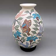 Polychrome jar with a flared opening and a sgraffito-and-painted butterfly, hummingbird, flower, leaf, and branch design
 by Sandra Lorena Arras of Mata Ortiz and Casas Grandes