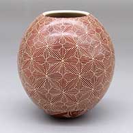 A red-on-white jar with a sgraffito fish and geometric design
 by Leonel Lopez Jr of Mata Ortiz and Casas Grandes