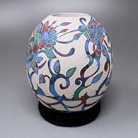 A polychrome jar with a sgraffito hummingbird, flower and vine design
 by Diana Loya of Mata Ortiz and Casas Grandes