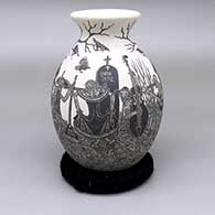 Black-on-white jar with a flared opening and a sgraffito Day of the Dead design
 by Hector Javier Martinez of Mata Ortiz and Casas Grandes