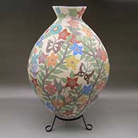 Large polychrome jar with a flared opening and a sgraffito-and-painted hummingbird, butterfly, birds nest, worm, flower, branch, and leaf design
 by Blanca Arras of Mata Ortiz and Casas Grandes